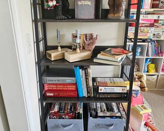 Black Shelving unit with books, DVDs and CDs