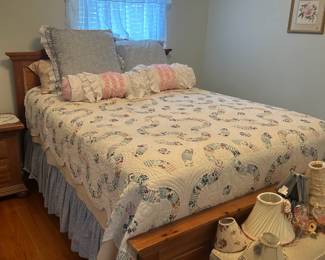 Full size bed with mattresses and bedding