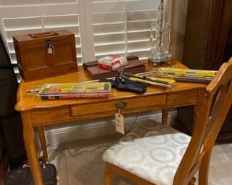 Gun accessories atop a multi-use desk/table with chair