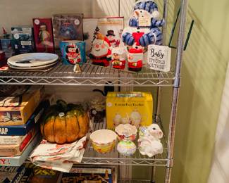we have two four shelf wire racks filled with holiday decorations and linens