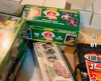 table filled with baseball, football, and basketball unopened cards