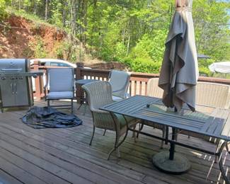Outdoor table with 6 chairs and umbrella, 2 additional chairs, gas grill