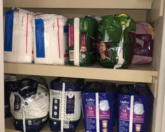 Adult diapers. Some new in box, others in open boxes.