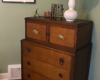 1900s tall boy dresser with tole painting and hidden drawers. Great condition. Available for pre sale on FB Marketplace.