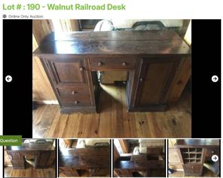 Lot # : 190 - Walnut Railroad Desk
2 doors concealing alphabetical cubbies, 3 drawers, 2 deep compartments under sections of desk top and measures 48" x 18" x 32" tall.