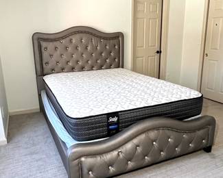 Queen size bed with a beautifully tufted headboard and a Sealy Performance mattress and box spring. Includes a sturdy frame with decorative detailing.