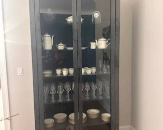 RH (Restoration Hardware) tall hammered metal cabinet with glass shelves.