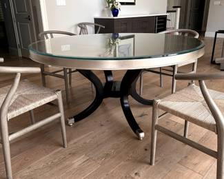 60" round dining table with thick glass top. Unique gold leaf design on table top. Black legs. 