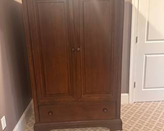 Stanley Furniture armoire in solid walnut. Has both shelves and a hanging rod for multiple types of use.