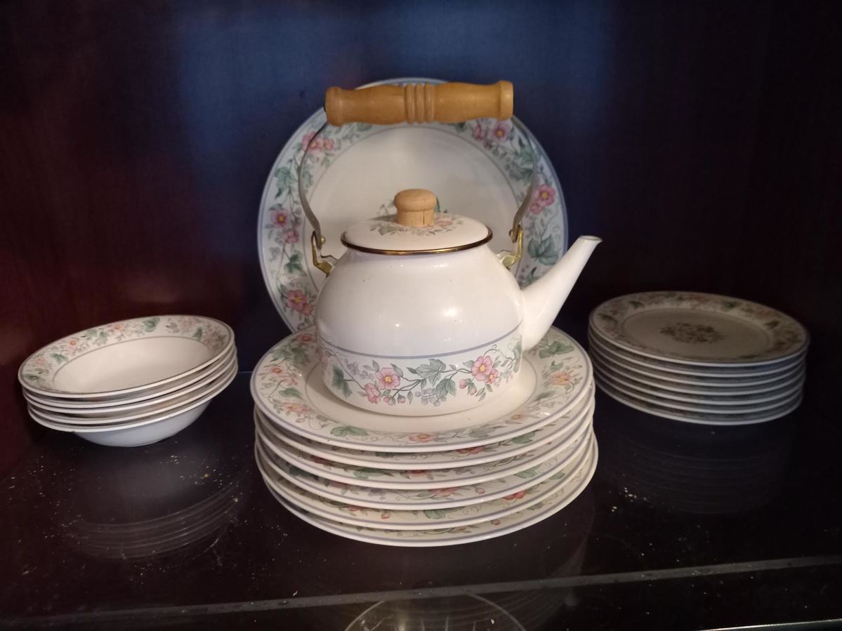 China SetElegant floral porcelain tea set with matching plates and saucers. Features a teapot with wooden handle, decorative floral pattern, and includes multiple serving plates and side dishes. Perfect for afternoon tea or display.