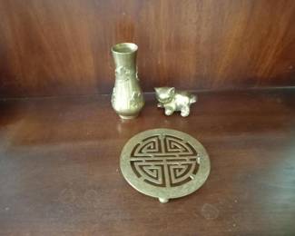 Asian-inspired decorative set featuring a jade green trivet with traditional Chinese longevity symbol, accompanied by a matching vase and small figurines. Beautiful accent pieces for an oriental-themed room or display.Decor pieces