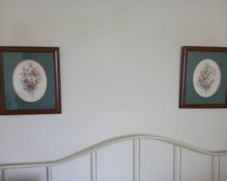 Pair of framed floral prints above white headboard