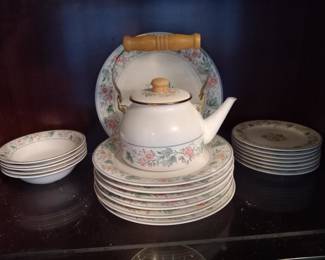 China SetElegant floral porcelain tea set with matching plates and saucers. Features a teapot with wooden handle, decorative floral pattern, and includes multiple serving plates and side dishes. Perfect for afternoon tea or display.