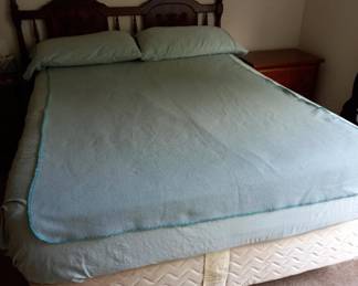 Queen bed with wooden headboard and box spring