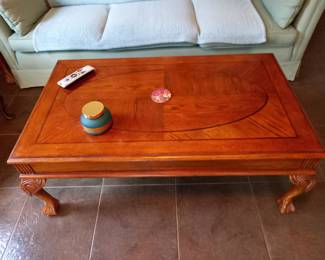 Wooden coffee table with carved legs and inlay design