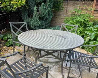 $240. Iron outdoor dining set. Table is 43" diameter x 29.5"h. As found issue on a couple of chairs shown in following photo. Cushions included.