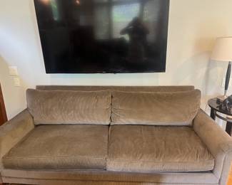 $860. Ralph Lauren sage/olive sofa with down cushions. 85.5"w x 39.5" d x 32.5"h. Samsung TV for sale during in-person shopping.