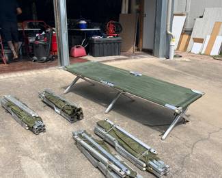 Several military cots for you and your friends to have a sleep over.