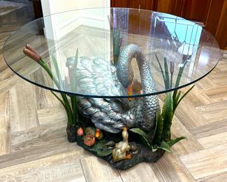 Polychrome cast bronze swan table base with round glass top.
