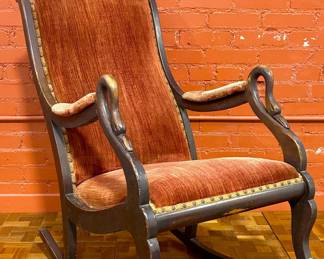 Antique early 1900s rocking chair with swan neck arm posts.