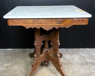 Antique Victorian Parlor Table in the Eastlake style, circa 1880, with marble top.
