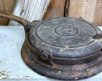 Antique cast iron stove top waffle iron.