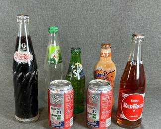 Assorted Collectible Soda Bottles and Cans