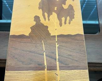 “Two Birches” wood inlay artwork featuring two birch trees. The artwork is made of different shades of wood, creating a contrast between the trees, the sky, and the ground