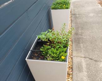 three self-watering planters