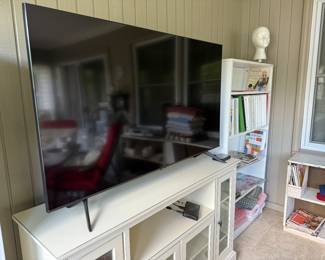 Large Samsung flatscreen television and television stand