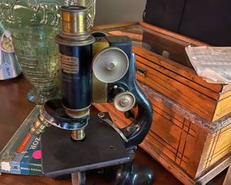 Antique microscope and wooden box with scales for weighing medicines .