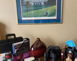 The framed picture is of the KU campus.  The items shown are on the desk top in the office.