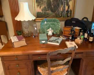 Beautiful and huge men's desk holding antique physician's items.