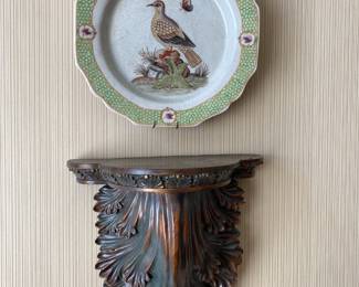One of a pair of wall shelves with game bird plates above.