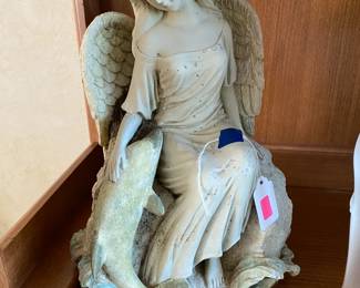 Angel figurine with sea motif.
