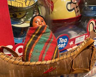 Skookum doll in canoe.