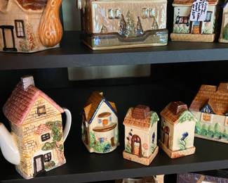 Cottage themed teapots, salt and pepper shakers, and other themed pieces.