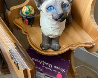Oh the piercing eyes of a Siamese cat!  He looks curious about who might purchase him.