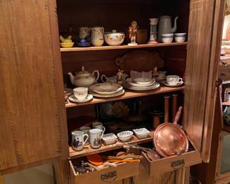 Primitive pie cabinet full of antiques.