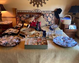 Guest bedroom laid out with trays of jewelry.  We have marked and bagged a huge number of items.