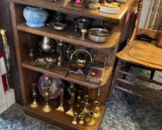 Shelves shown are attached to the pine desk. Lots of brass trinkets, and a press back chair