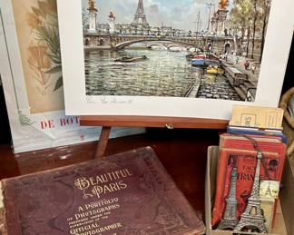 Paris-themed lot featuring antique books, Prince bottle, opener, necklace, etc.