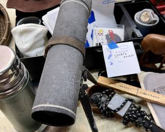 Sportsman's lot featuring scope, targets, reflective trail marking tacks, miscellaneous gear, carrying case, and decor