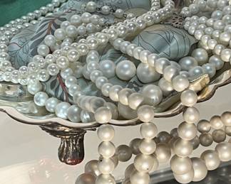 Lots of faux pearl necklaces in a silver plate, clamshell serving dish