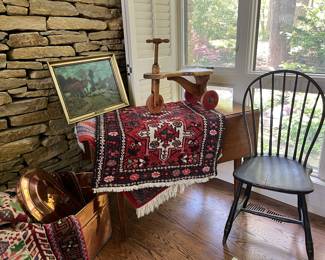 Primitive drop leaf table along with Persian rug and copper boiler.