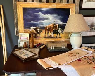 Wonderful cow painting with Antique drop leaf table and beautiful crewel work.