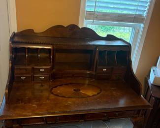 Beautiful desk with several drawers and nooks to place important papers and office supplies.