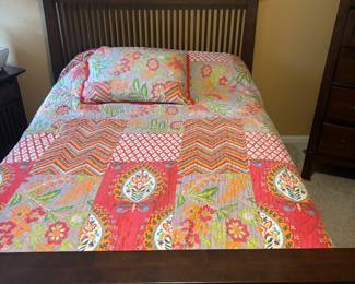 Part of the bedroom set. Full sized bed with dark wood headboard. Boxspring and comfortable mattress included.