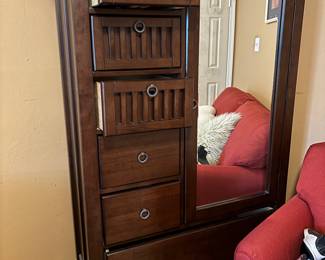 Matches the bed frame and the side table. Tall dresser with shelves and drawers and a full size mirror.
