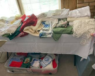 Lots of table linens-- tablecloths, napkins, table runners, and placemats